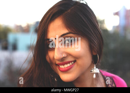 Belle femme indienne en vêtements traditionnels, smiling at camera.