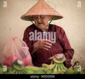 Vieille Femme vendant des bananes sur le marché intérieur au Vietnam Banque D'Images