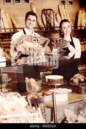 Le personnel offrant café et gâteaux éponge fantaisie à vendre à sweet-shop Banque D'Images