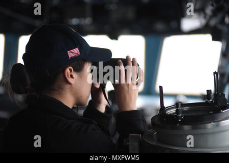 161130-N-JI086-224 - Détroit de Gibraltar (nov. 30, 2016), l'étoile Caroline Evans, à partir de Peachtree City, Ga., regarde à travers une paire de jumelles alors qu'elle se regarder comme agent de la manoeuvre à bord du destroyer lance-missiles USS Porter (DDG 78) 30 novembre, 2016. Porter est en cours d'opérations navales dans la sixième flotte américaine zone d'opérations à l'appui de la sécurité nationale des États-Unis en Europe. (U.S. Photo par Seaman marine Ford Williams/libérés) Banque D'Images