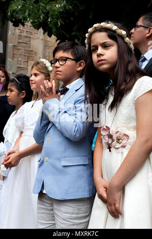 Les enfants alignés à l'extérieur d'une église à leur première communion, Barcelone, Espagne. Banque D'Images