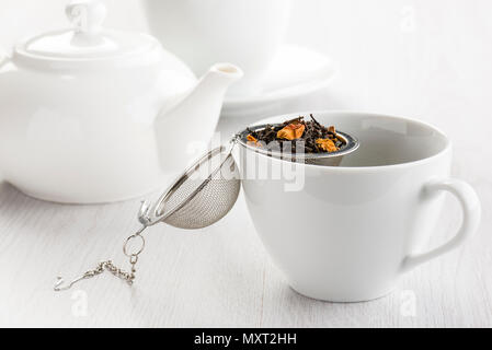 Thé blanc a ouvert ses portes le mélange de plantes médicinales avec tasse pour le thé. Banque D'Images