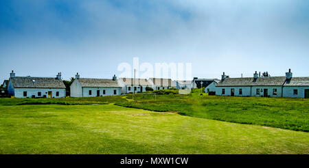 Peint blanc chalets sur Easdale Island Banque D'Images