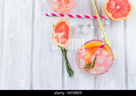 Cocktail avec de la glace et de tranches de pamplemousse, les ingrédients pour un verre sur une table en bois blanc, copy space Banque D'Images
