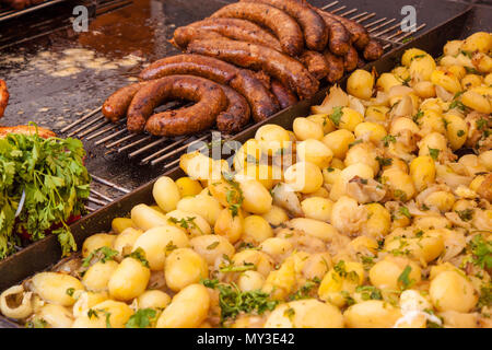 Accompagné de pommes de terre et des saucisses frites avec du persil sur une échoppe de marché à Budapest, Hongrie. L'alimentation de rue typiquement européen. Banque D'Images