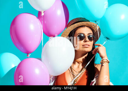 Belle Bohemian Girl standing avec ballons d'hélium isolé sur turquoise Banque D'Images