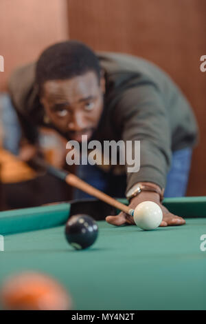 African American man playing in pool at bar Banque D'Images