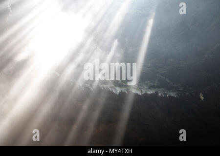 Lumière du soleil à travers la grotte grotte Jomblang trou à midi près de l'heure à Yogyakarta, Indonésie Banque D'Images