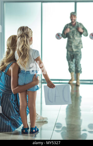 Portrait de Mère et fille rencontre père en uniforme militaire à l'aéroport Banque D'Images