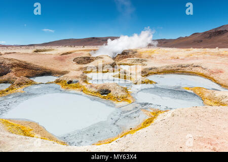 L'activité volcanique du sol de Mañana en Bolivie entre le Chili et l'Uyuni Salt Flat. Puits de boue et les fumerolles de vapeur d'eau les sentiers dans les Andes. Banque D'Images