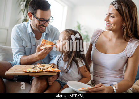 Portrait de famille heureuse partager une pizza à la maison Banque D'Images