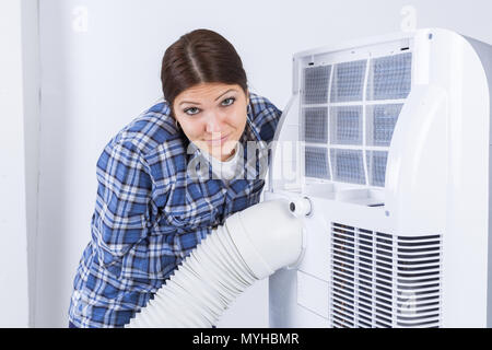 Travailleur féminin avec tuyaux de climatisation Banque D'Images