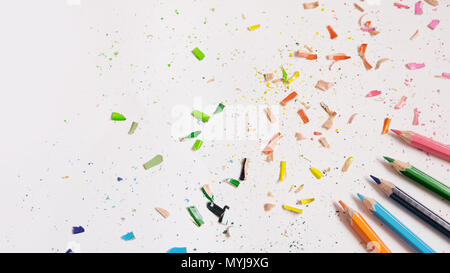 Mise à plat des crayons de couleur avec des copeaux de crayon dispersés tout autour, on a white background. Banque D'Images