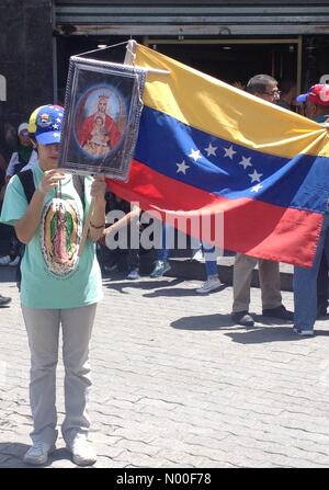 Av Abraham Lincoln, Caracas, Venezuela, Distrito Capital. 17 Juin, 2017. Une jeune femme tenant une image de la Vierge de Coromoto et le drapeau vénézuélien lors d'une manifestation contre le gouvernement vénézuélien Crédit : Luis Molina/StockimoNews/Alamy Live News Banque D'Images