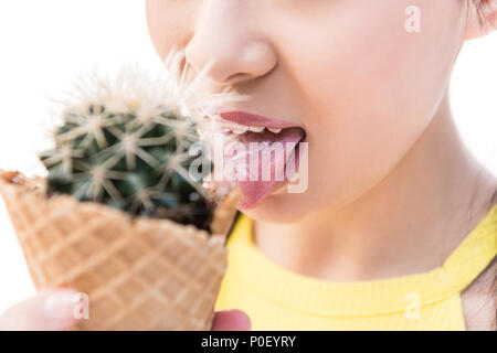 Cropped shot of young asian woman licking cactus en cornet gaufré isolated on white Banque D'Images