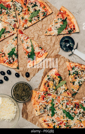 Tranches de pizza italienne et ingrédients culinaires sur fond clair Banque D'Images