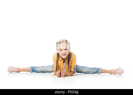 Petit enfant souriant stretching, split et faire looking at camera isolated on white Banque D'Images