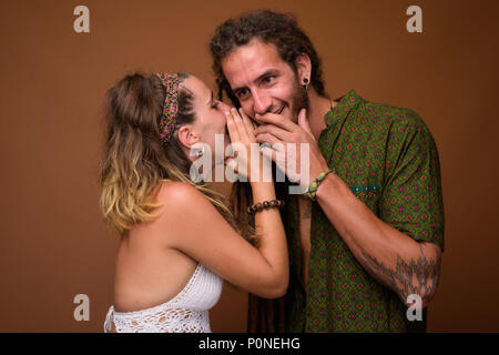 Young Hispanic couple ensemble contre fond brun Banque D'Images