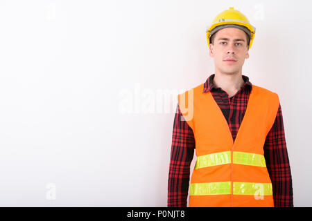 Young handsome man construction worker against white background Banque D'Images