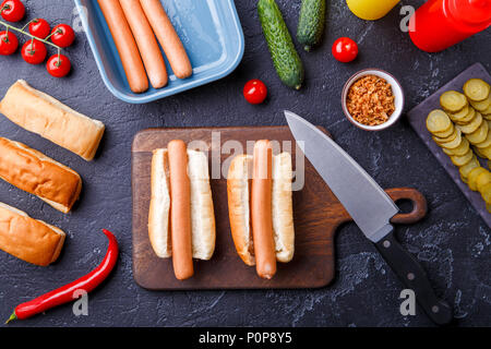 Photo le haut de deux hot-dogs sur une planche à découper sur la table avec saucisses Banque D'Images