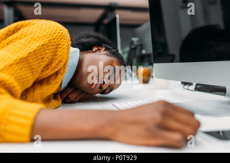 Surchargés de young african american woman sleeping on travailler au bureau moderne Banque D'Images