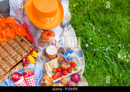 Pique-nique dans la célébration de la journée du roi. Déjeuner dans le jardin. De fruits et de pâtisseries. Chapeau Orange. Printemps dans les Pays-Bas. Texte et Carte postale Banque D'Images