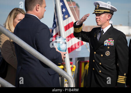 161014-N-ZI635-633 BALTIMORE (oct. 14, 2016) Peter Spiro, fils de l'ancien colonel Michael Spiro, fournit l'urne contenant les cendres de son père pour le Capitaine Scott Tait, directeur général, à bord d'avenir USS Zumwalt (DDG 1000). Le colonel Spiro était le long temps aide de camp de l'Adm. Elmo Zumwalt, le navire homonyme. Zumwalt, le navire de tête d'une classe de la prochaine génération de destroyers à missions multiples conçu pour accroître sa puissance navale de la mer, sera mise en service le 15 octobre à Baltimore. (U.S. Photo de la marine du Maître de 2e classe George M. Bell/libérés) Banque D'Images