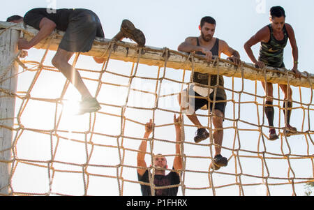 Monter le mur corde concurrents pendant l'obstacle Pensacola Mud Run 8 oct. Le service actif et les membres en service de réserve des bases militaires locales est venu à se salir dans les cinq-mille, 20-obstacle défi. (U.S. Air Force photo/Tech. Le Sgt. Sam King) Banque D'Images