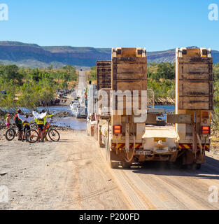 Défi 2018 Gibb les cyclistes, les véhicules de soutien et un camion semi-remorque franchissant la rivière Pentecôte Gibb River Road Australie Kimberley Banque D'Images