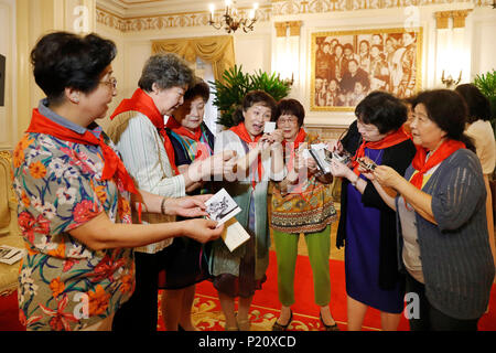 Shanghai, Chine. 12 Juin, 2018. Les gens, les membres d'une troupe d'art à l'Institut du bien-être de la Chine (CWI) Palais des Enfants, regardez les photos anciennes au CWI le Palais des Enfants de Shanghai, la Chine orientale, le 12 juin 2018. Cette année marque le 80e anniversaire du CWI, fondée par Soong Ching Ling en 1938. L'Organisation de Shanghai se concentre sur la santé maternelle et infantile, l'éducation et de la protection sociale. Soong Ching Ling, né à Shanghai en 1893, était l'épouse de révolutionnaires chinois du Dr. Sun Yat-sen, qui a dirigé la révolution de 1911. Credit : Gao Feng/Xinhua/Alamy Live News Banque D'Images