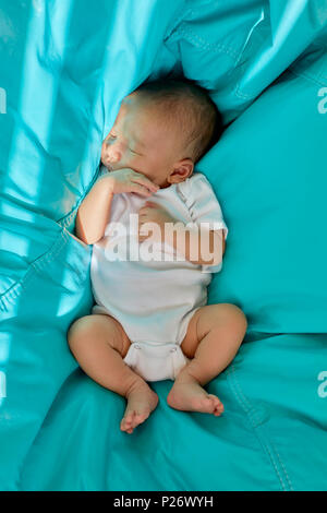 Bébé Garçon endormi dans une chaise de sac d'haricot bleu sarcelle Banque D'Images