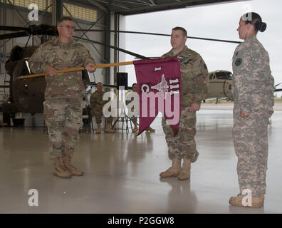 HOPE HULL, Ala. (sept. 17, 2016) -- Le Colonel Zachary E. Maner (à gauche), le commandant de la 122e Commande des troupes, Alabama Army National Guard, présente l'unité de détachement 2 couleurs, l'entreprise C (Air Ambulance), 1er Bataillon, 111e Régiment d'aviation, 122e Commande des troupes, Alabama Army National Guard pour la première fois au Capitaine Ryan J. Langhammer (centre) comme le s.. Elaine Spruill (à droite), une ambulance d'air sous-officier affecté au détachement, observe l'échange symbolique. Langhammer devient le premier commandant du détachement dans le cadre d'une cérémonie pour activer l'unité Banque D'Images