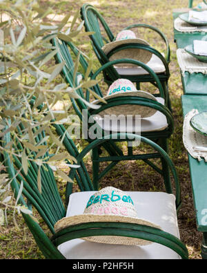 Berbère des chapeaux de paille sur les chaises vertes fixé à une table de jardin Banque D'Images
