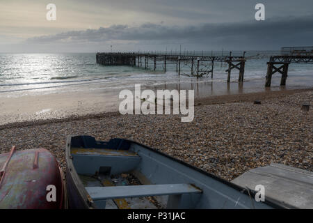 Une belle et de l'atmosphère à Seascape totland pier sur l'île de Wight. Lumière du soir au coucher du soleil et l'atmosphère moody en basse lumière. Banque D'Images