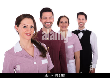 Le personnel de l'hôtel Group Of Smiling Standing in a Row Banque D'Images