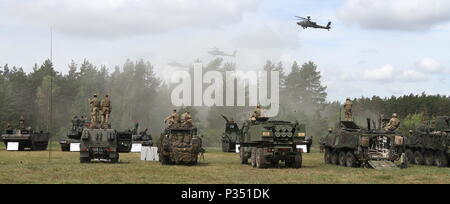 Soldats multinationales trônent au sommet des véhicules et équipements militaires à regarder point culminant d'entraînement de Sabre à la grève 18 Bemowo Piskie Domaine de formation, la Pologne le 15 juin 2018. Grève 18 Sabre est la huitième édition de l'armée américaine de longue date par l'Europe de la formation coopérative exercice visant à accroître l'interopérabilité entre les alliés et les partenaires régionaux. (Michigan Army National Guard photo de 1er lieutenant Erica Mitchell/ libéré). Banque D'Images