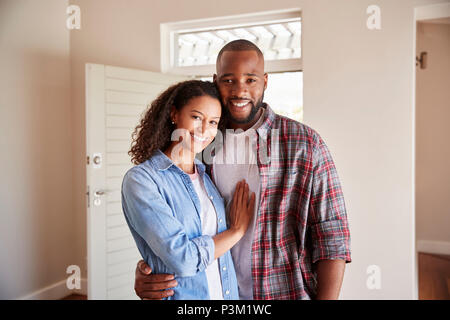 Portrait de couple par porte avant dans le salon de New Home Banque D'Images