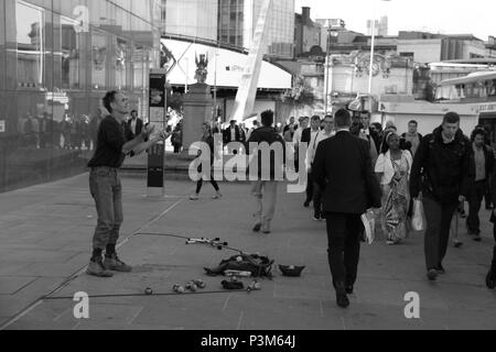 Jongleur de tenter de divertir les navetteurs et les employés de bureau sur le pont de Londres, Londres, Angleterre, Royaume-Uni, PETER GRANT Banque D'Images