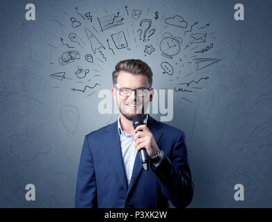 Businessman parlant au micro avec des doodles sur sa tête Banque D'Images