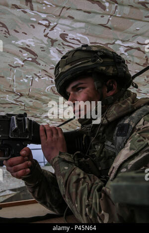 L'Armée britannique Pvt. Callum Barton de la Compagnie Alpha, 3e Bataillon du Régiment de parachutistes fournit la sécurité tout en menant des opérations défensives au cours de réponse rapide 16 entraînement physique à la zone d'entraînement, un Hohenfels partie de la multinationale, Centre de préparation conjointe en Allemagne, Hohenfels, Jun. 17, 2016. La réaction rapide de l'exercice est l'un des premiers événements de formation en intervention de crise militaire pour les forces aéroportées dans le monde. L'exercice est conçu pour améliorer l'état de préparation de la base de combat de la Force de réaction des Etats-Unis dans le monde - en ce moment la 82nd Airborne Division, 1ère Brigade Com Banque D'Images