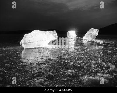 Pièces de fonte de blocs de glace. Rétroéclairage de couleur forte brillance des fissures profondes, low angle view. Loin de l'horizon. Banque D'Images