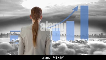 Image composite de woman looking at skyscraper avec graphiques statistiques Banque D'Images