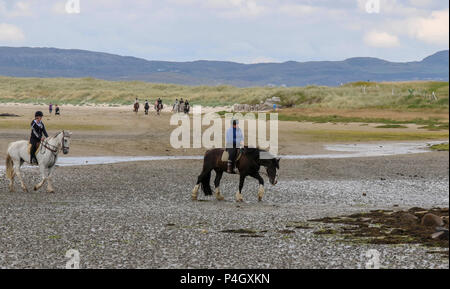 Les cavaliers d'une école d'équitation à Dunfanaghy Comté de Donegal en Irlande, sur une plage de sable de Sheephaven Bay. Banque D'Images