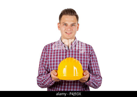 Portrait of young constructeur portant chemise à carreaux maintenant casque de protection jaune isolé sur Banque D'Images