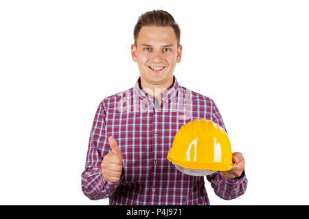 Jeune ingénieur avec casque jaune showing Thumbs up sur fond isolé Banque D'Images