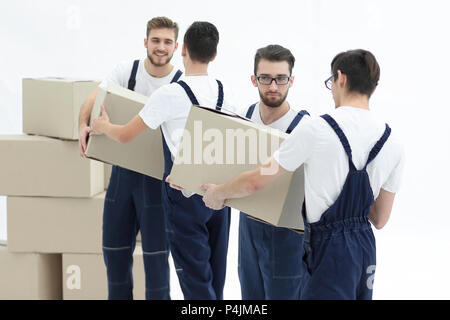 Les travailleurs passent chaque photo autres cases lors du déplacement d'appartements. Banque D'Images