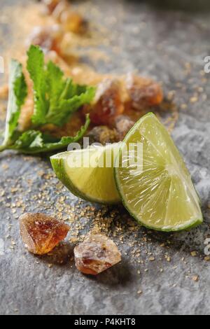 Ingrédients pour un mojito : menthe, limes et le sucre Banque D'Images