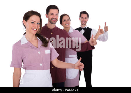 Le personnel de l'hôtel Group Of Smiling Standing in a Row Banque D'Images