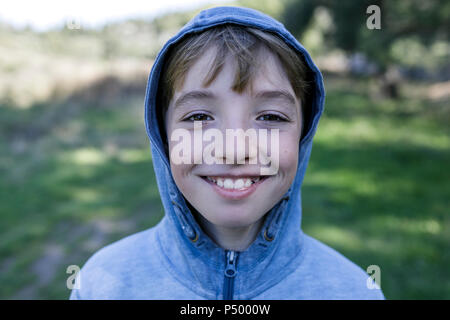 Portrait of laughing boy wearing blue Hooded Jacket Banque D'Images