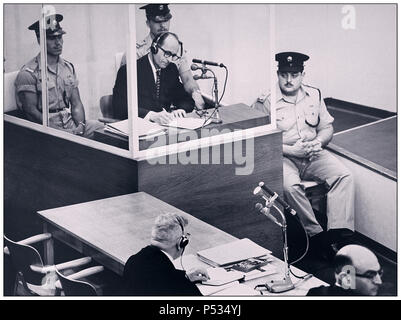 1961 Le Défendeur Adolf Eichmann, le criminel allemand de guerre nazi, prend des notes lors de son procès à Jérusalem. Il était chargé de transporter des millions de Juifs européens dans des camps de mort.Le stand de verre dans lequel Eichmann était assis a été érigé pour le protéger de l'assassinat. Il a été reconnu coupable et la peine de mort a été prononcée et dûment exécutée Banque D'Images
